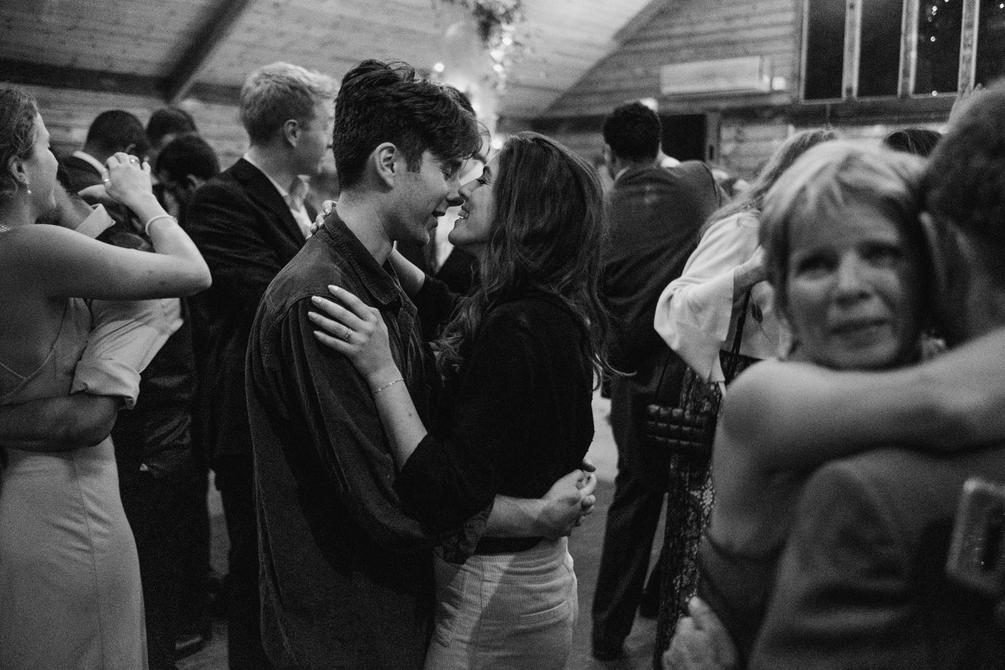 A natural wedding photo with guests enjoying Sophie and Chris's wedding day in Surrey. By York Place Studios who are London and UK award winning documentary photographers