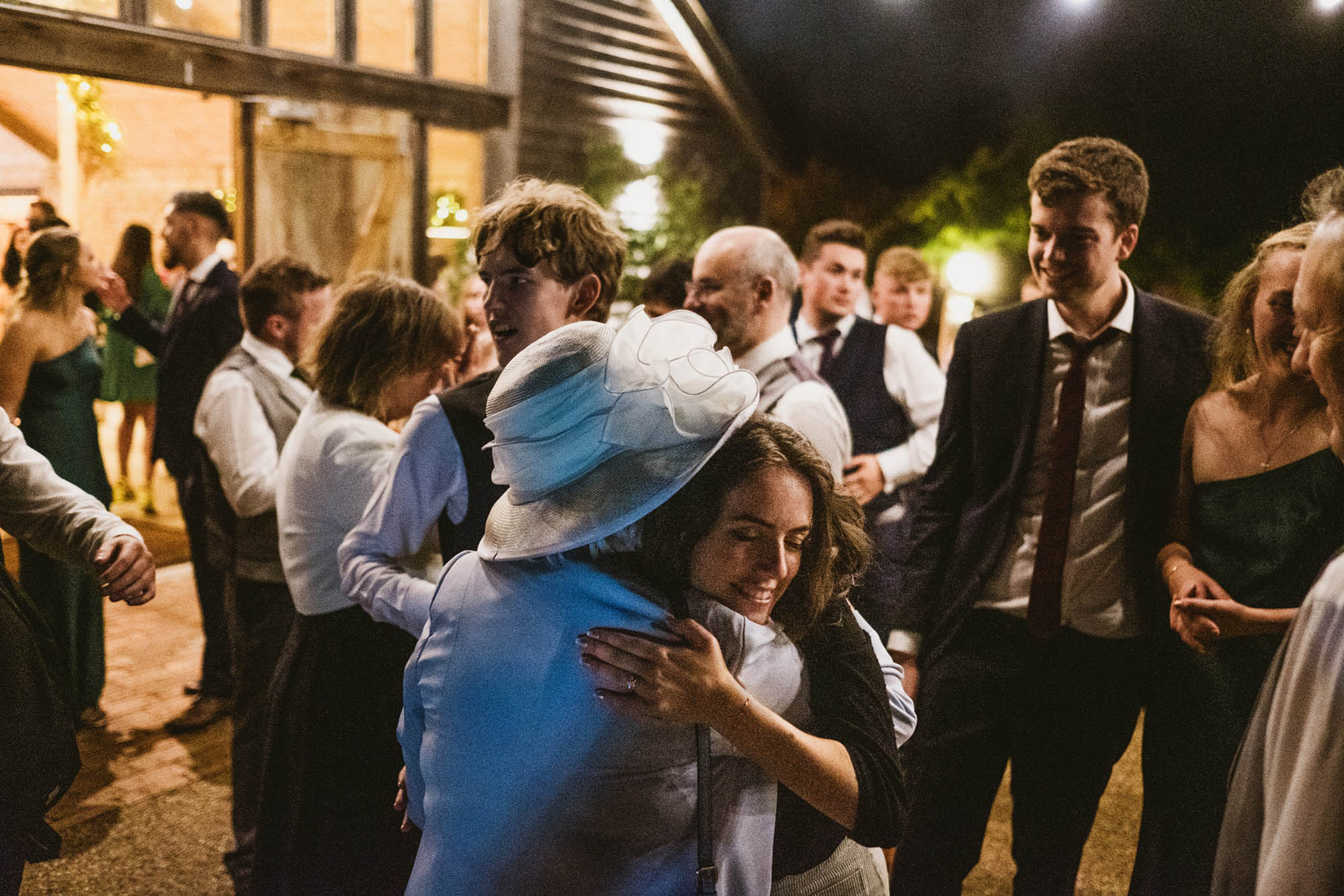 An authentic, unposed wedding image from High Billinghurst Farm in Surrey with guests enjoying Sophie and Chris's wedding day in Surrey. By York Place Studios who are London based documentary wedding photographers