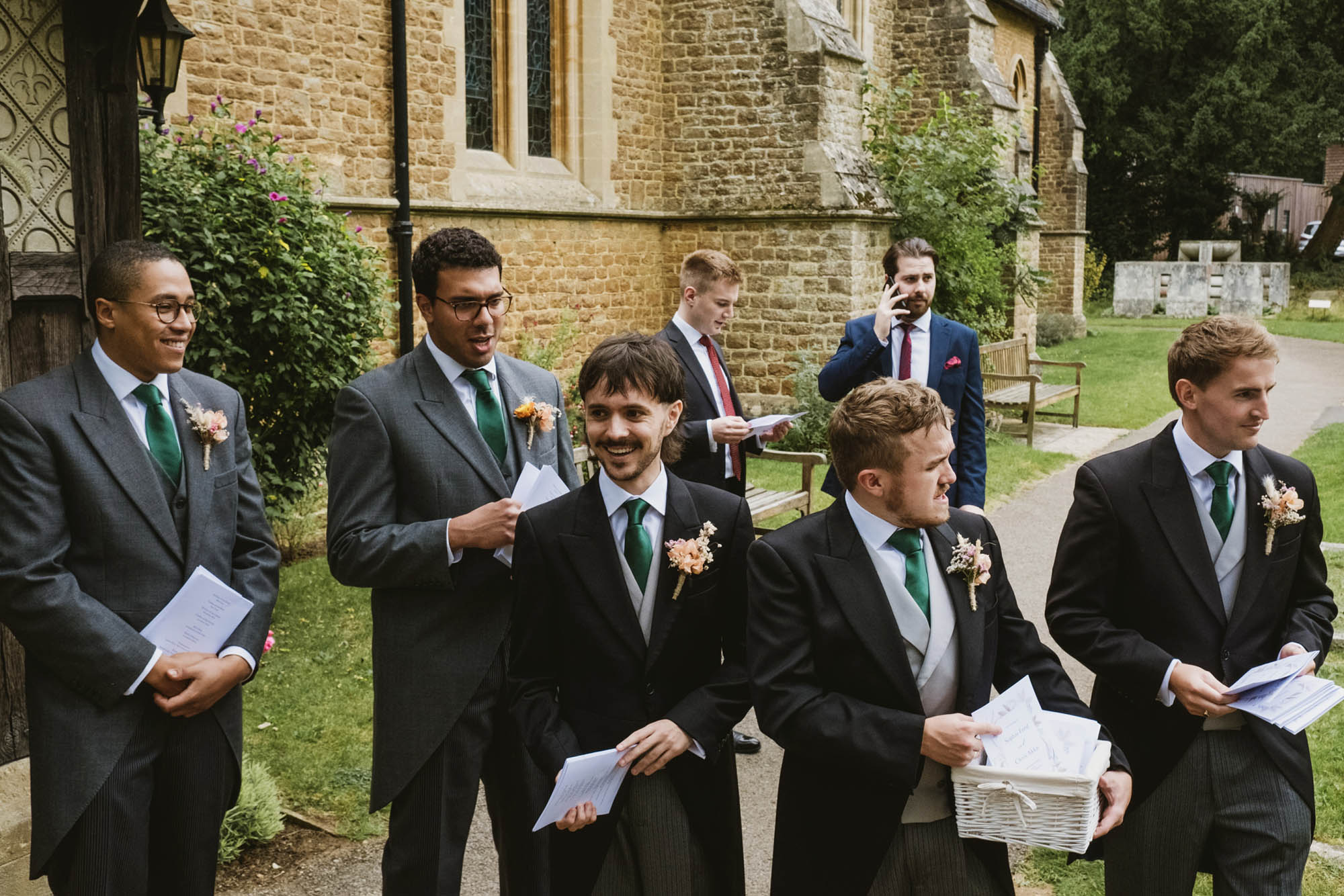 An authentic, unposed wedding image from High Billinghurst Farm with guests smiling Sophie and Chris's wedding day in Surrey. By wedding photographers and videographers York Place Studios