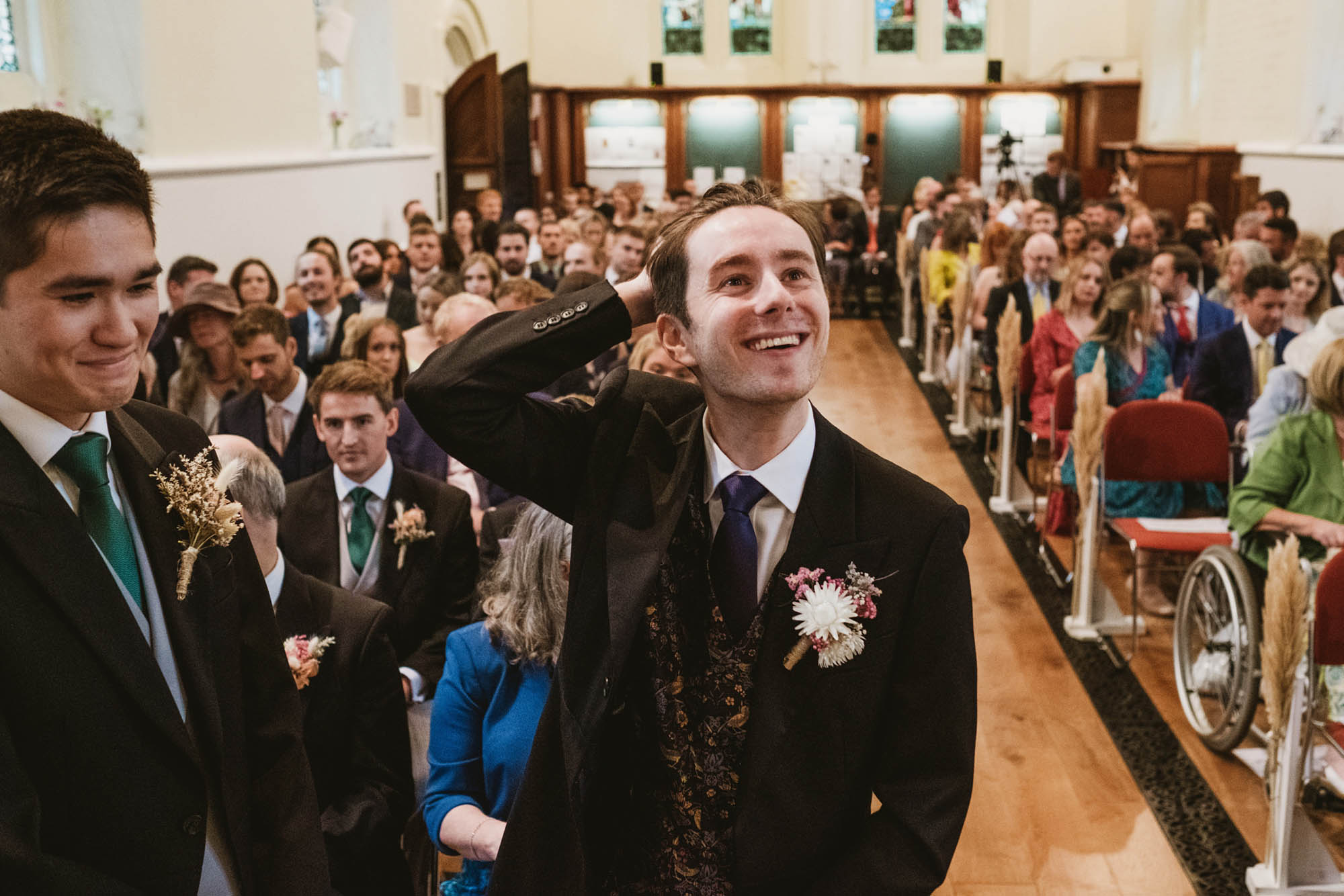 An authentic, unposed wedding image from High Billinghurst Farm in Surrey with guests enjoying Sophie and Chris's wedding day in Surrey. By York Place Studios who are London based documentary wedding photographers