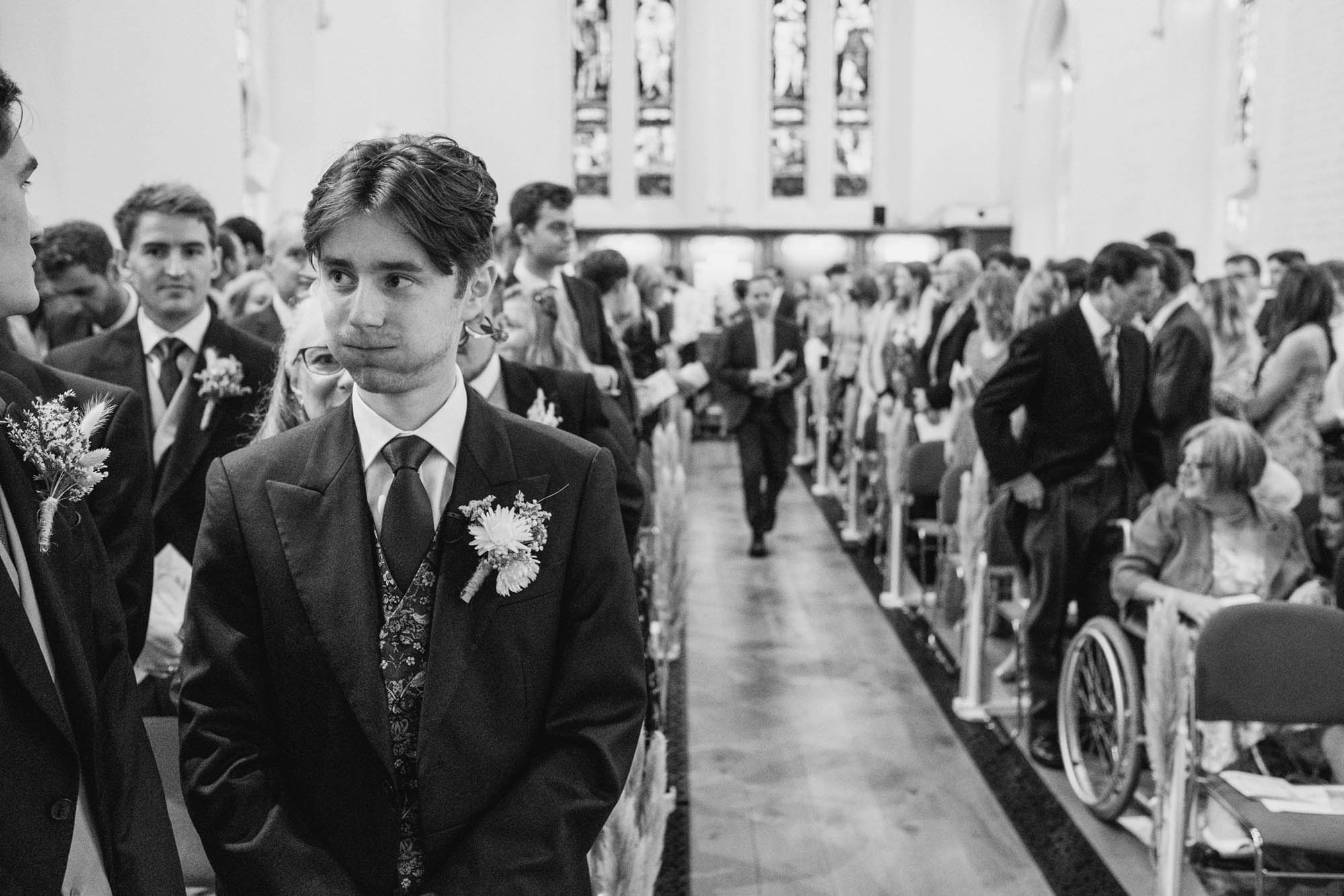 A natural wedding photo with guests enjoying Sophie and Chris's wedding day in Surrey. By York Place Studios who are London and UK award winning documentary photographers