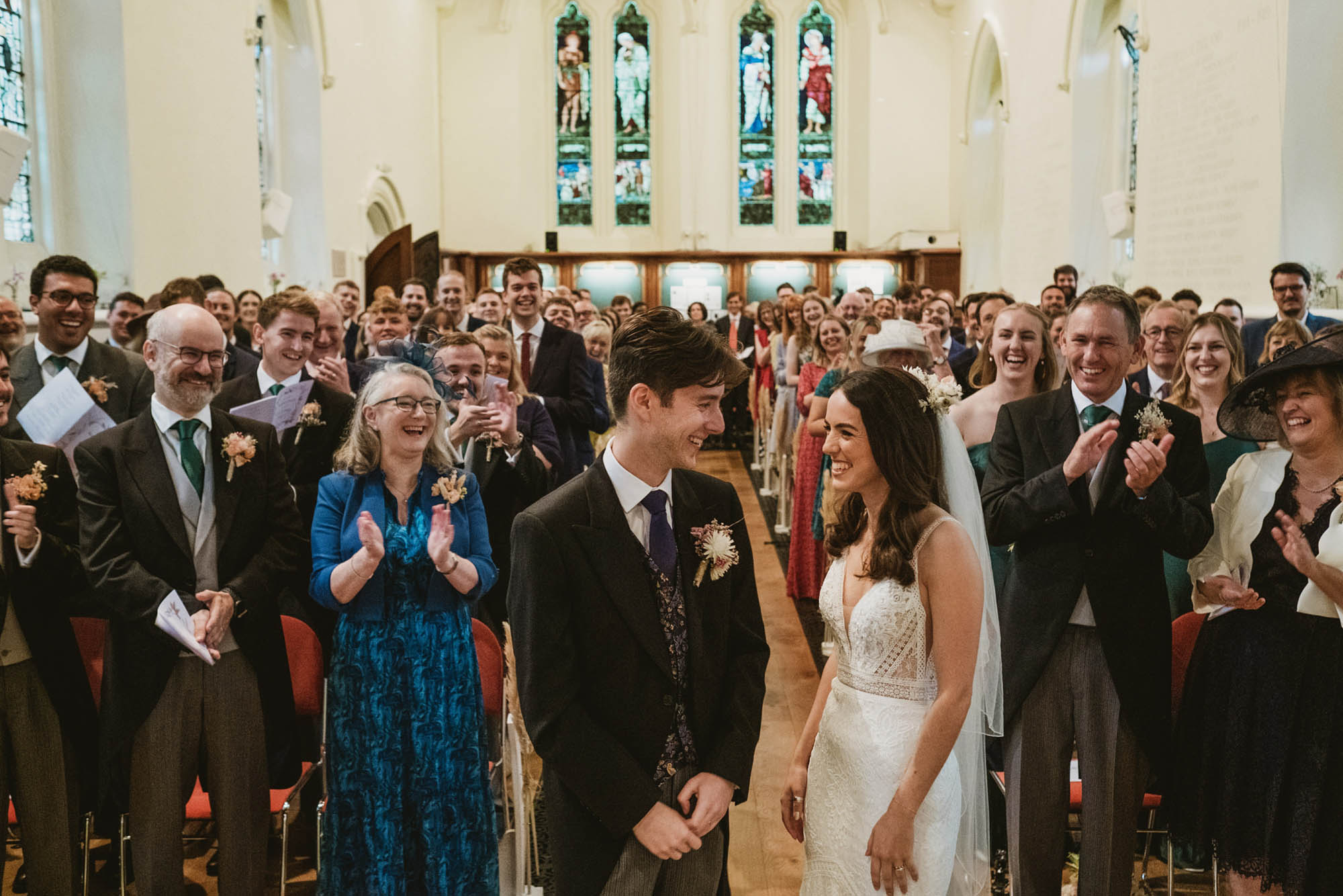 An authentic, unposed wedding image from High Billinghurst Farm in Surrey with guests enjoying Sophie and Chris's wedding day in Surrey. By York Place Studios who are London based documentary wedding photographers