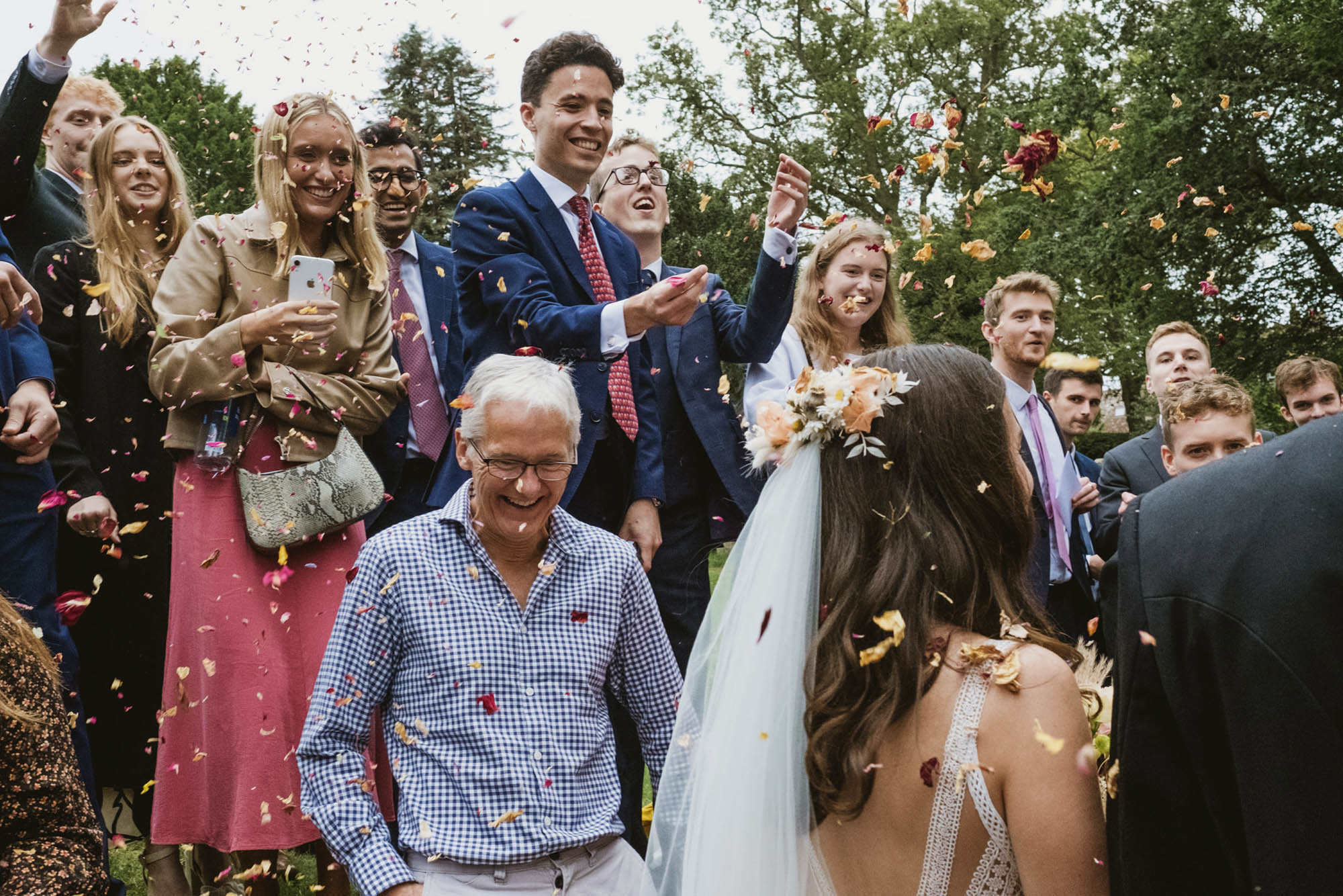A natural wedding photo with guests enjoying Sophie and Chris's wedding day in Surrey. By York Place Studios who are London and UK award winning documentary photographers