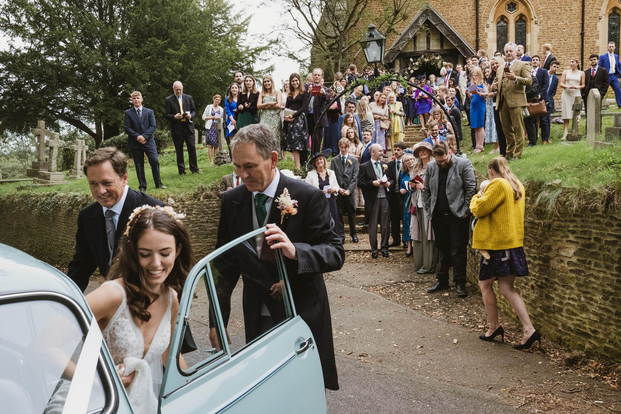 An authentic unposed wedding image with guests enjoying Sophie and Chris's wedding day in Surrey. By York Place Studios who are London and UK documentary photographers