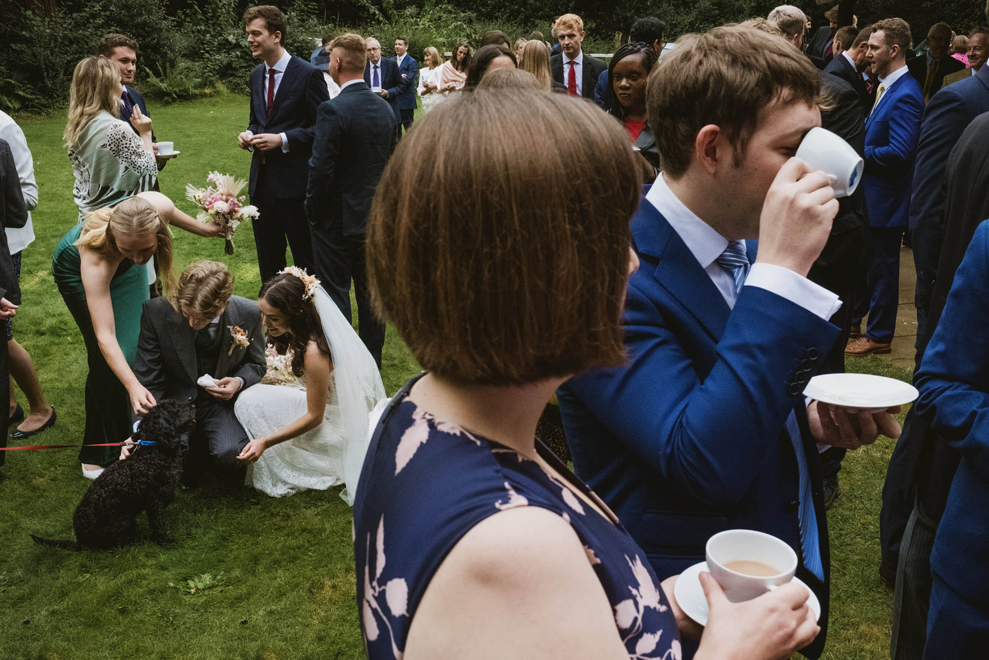 An authentic, unposed wedding image from High Billinghurst Farm with guests smiling Sophie and Chris's wedding day in Surrey. By wedding photographers and videographers York Place Studios