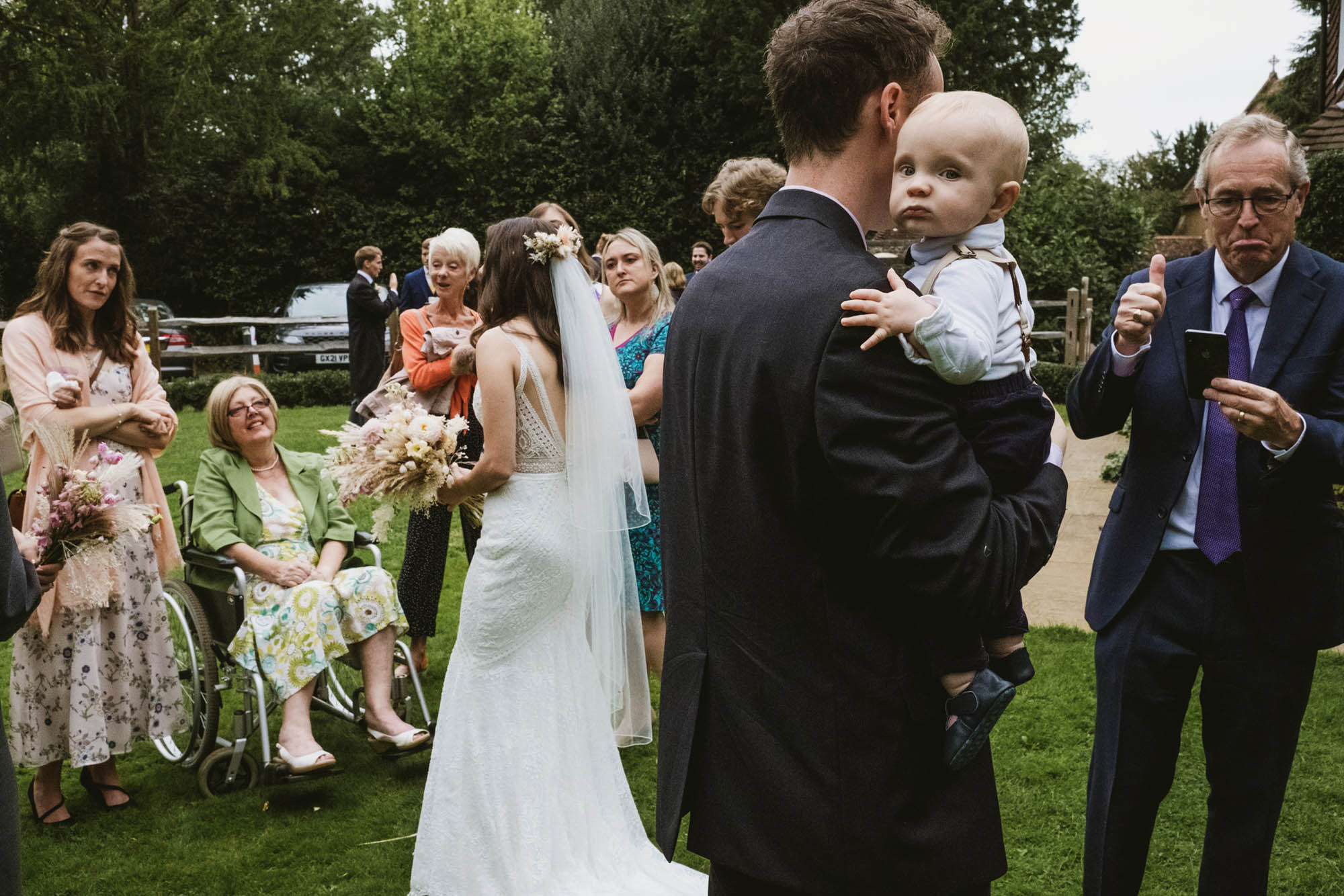 An authentic unposed wedding image with guests enjoying Sophie and Chris's wedding day in Surrey. By York Place Studios who are London and UK documentary photographers