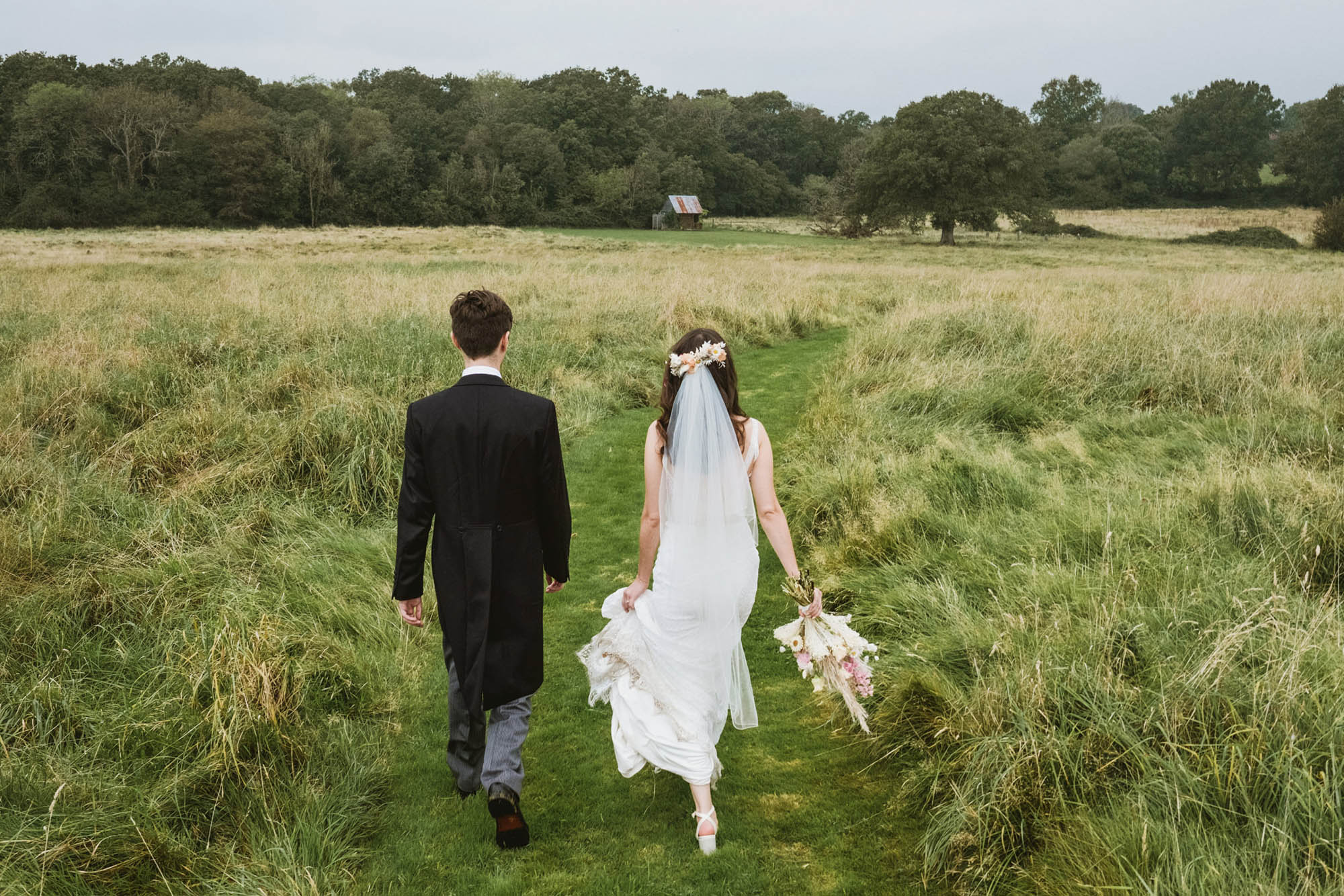 An authentic, unposed wedding image from High Billinghurst Farm in Surrey with guests enjoying Sophie and Chris's wedding day in Surrey. By York Place Studios who are London based documentary wedding photographers