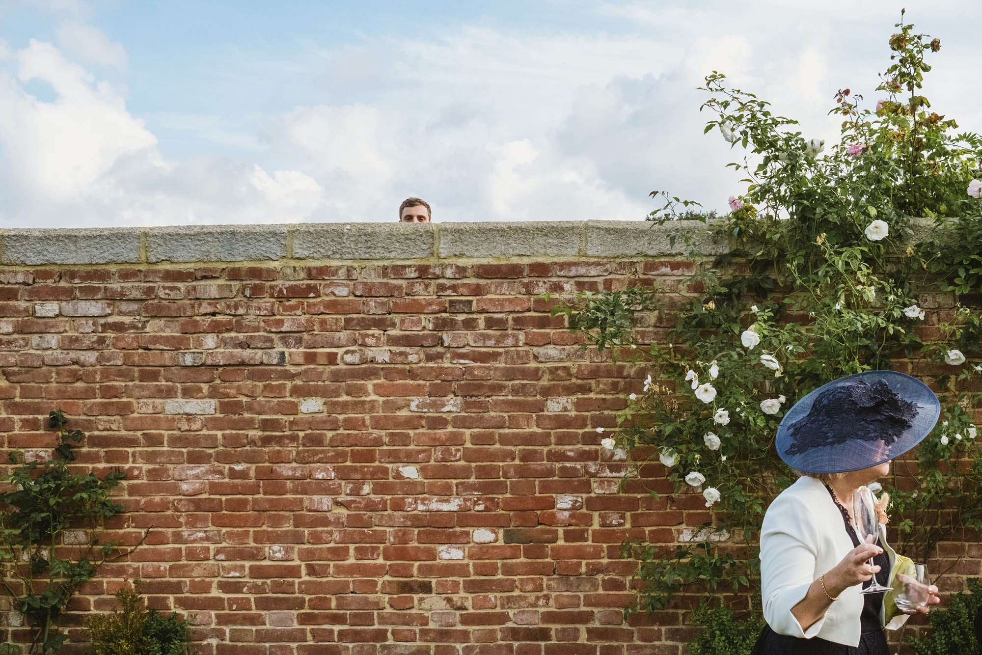 An authentic, unposed wedding image from High Billinghurst Farm with guests smiling Sophie and Chris's wedding day in Surrey. By wedding photographers and videographers York Place Studios