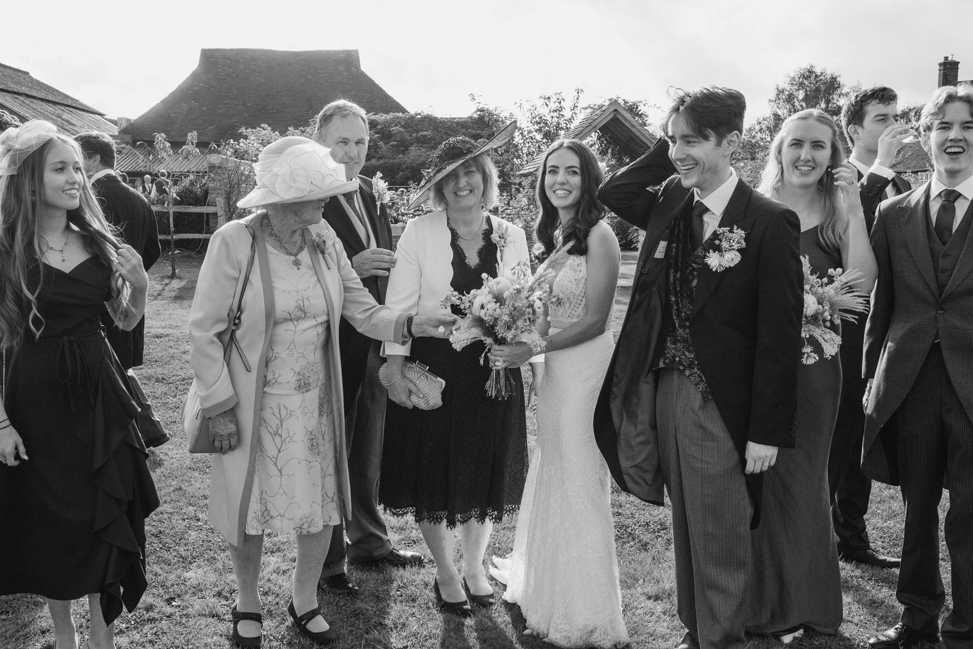 An authentic, unposed wedding image from High Billinghurst Farm in Surrey with guests enjoying Sophie and Chris's wedding day in Surrey. By York Place Studios who are London based documentary wedding photographers