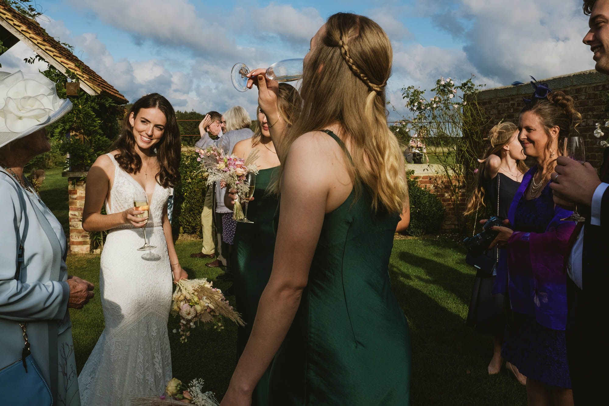An authentic, unposed wedding image from High Billinghurst Farm with guests smiling Sophie and Chris's wedding day in Surrey. By wedding photographers and videographers York Place Studios