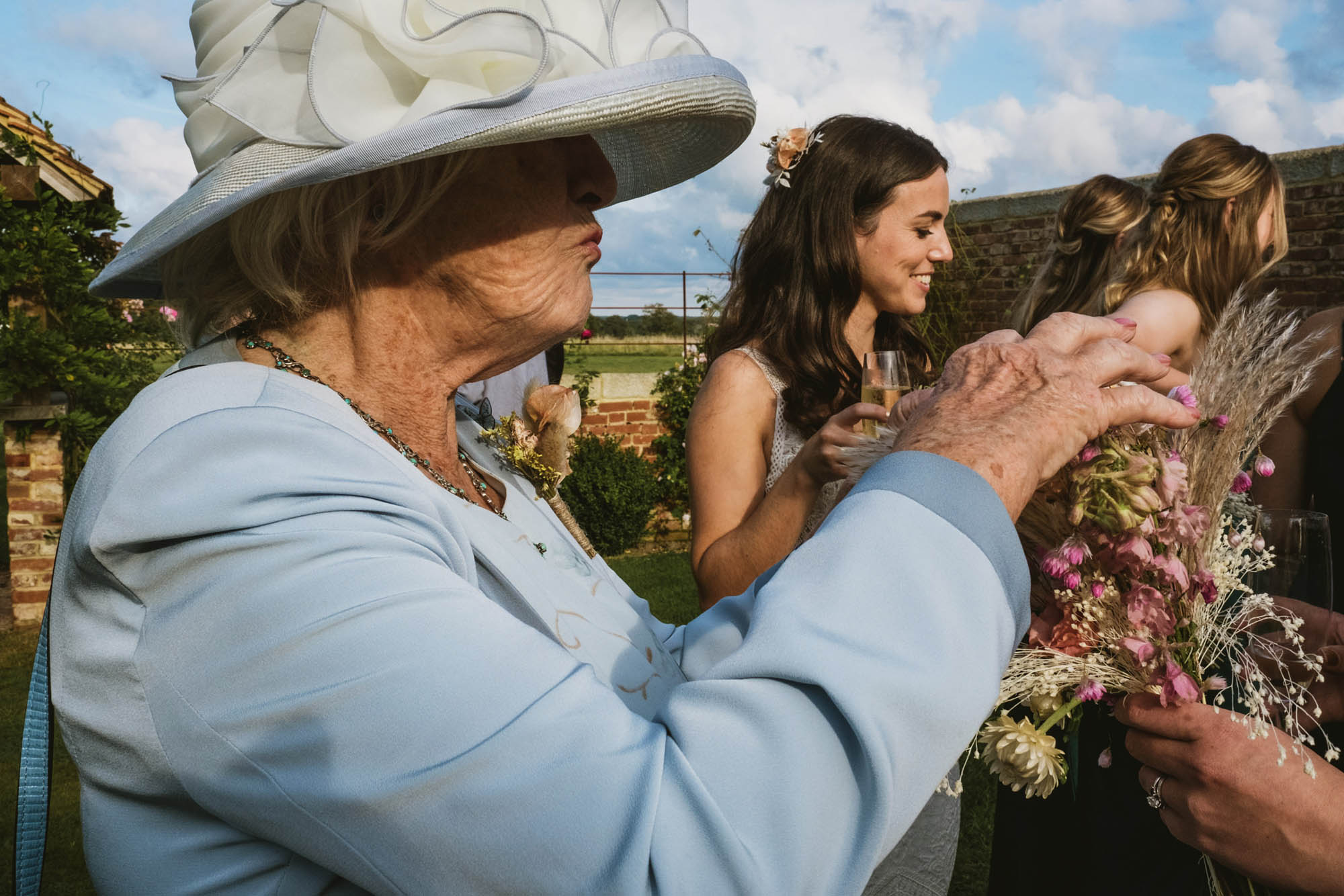 An authentic, unposed wedding image from High Billinghurst Farm in Surrey with guests enjoying Sophie and Chris's wedding day in Surrey. By York Place Studios who are London based documentary wedding photographers