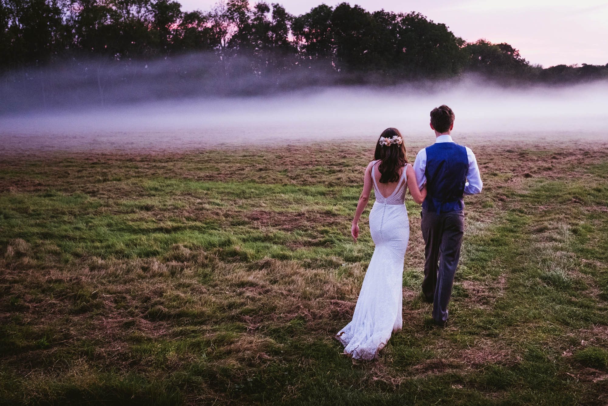 An authentic, unposed wedding image from High Billinghurst Farm with guests smiling Sophie and Chris's wedding day in Surrey. By wedding photographers and videographers York Place Studios