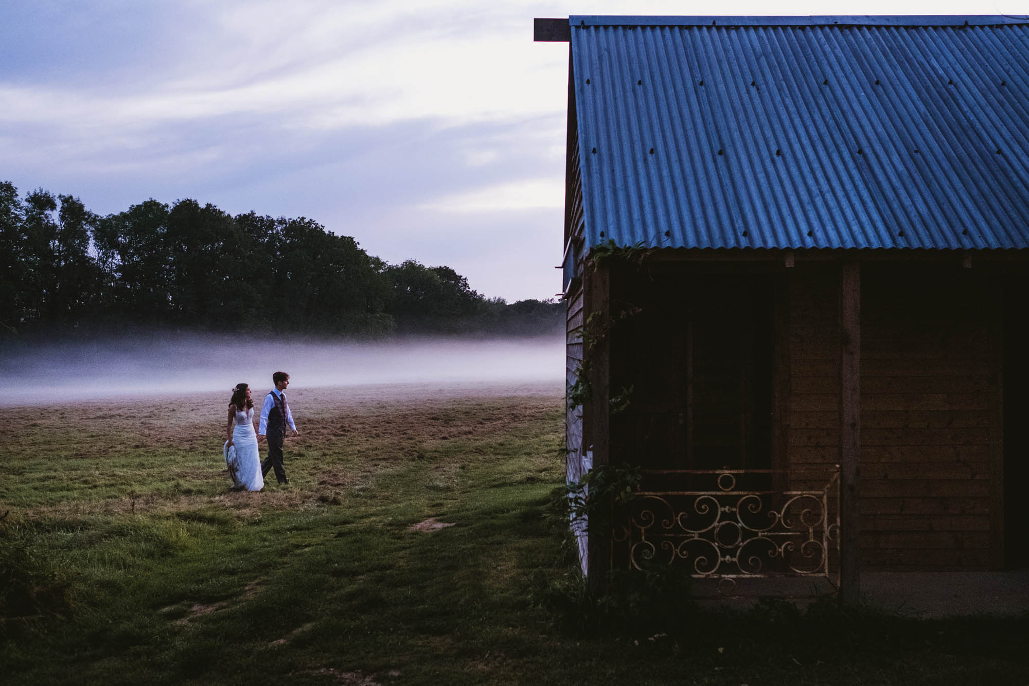 An authentic, unposed wedding image from High Billinghurst Farm with guests smiling Sophie and Chris's wedding day in Surrey. By wedding photographers and videographers York Place Studios