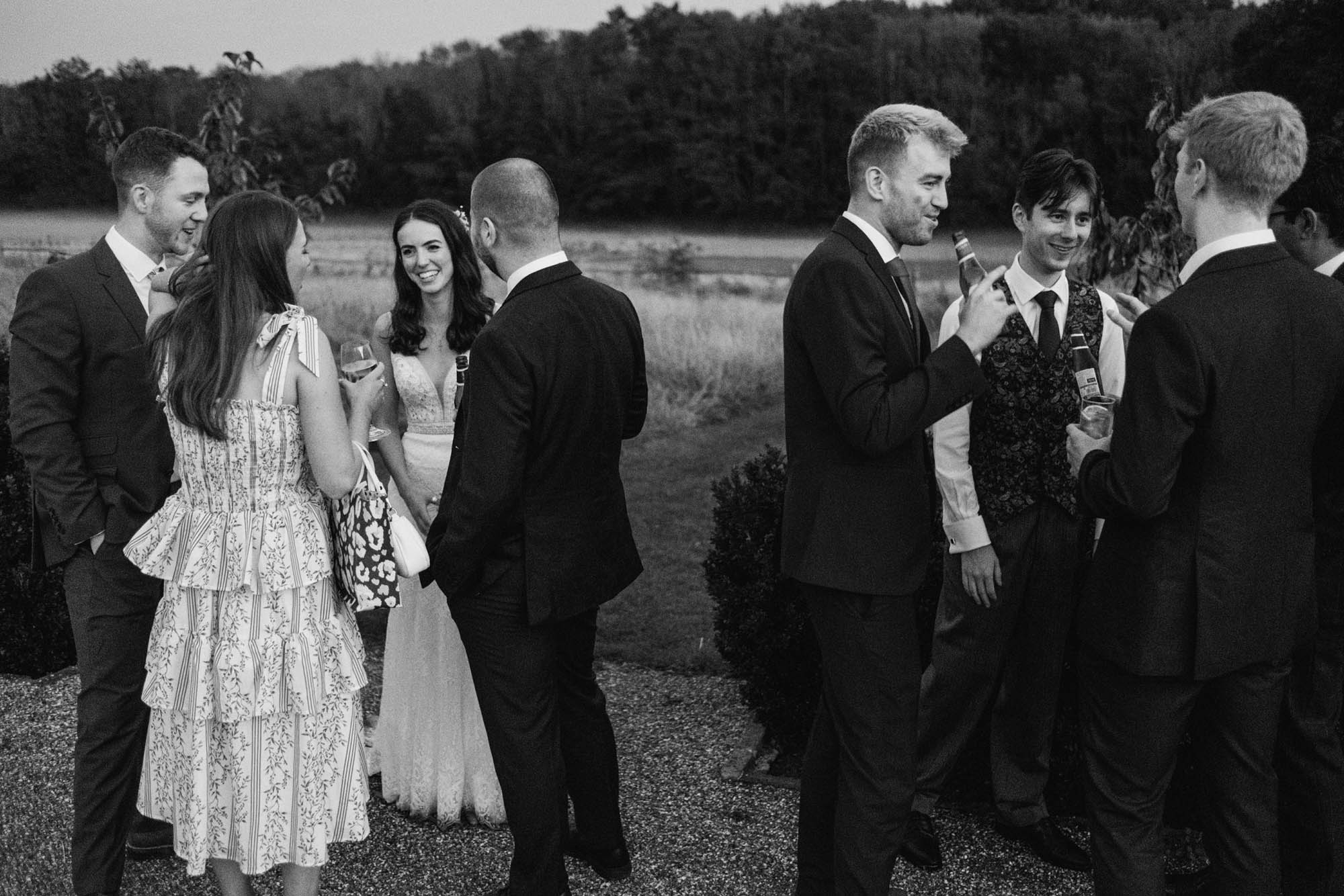 An authentic unposed wedding image with guests enjoying Sophie and Chris's wedding day in Surrey. By York Place Studios who are London and UK documentary photographers