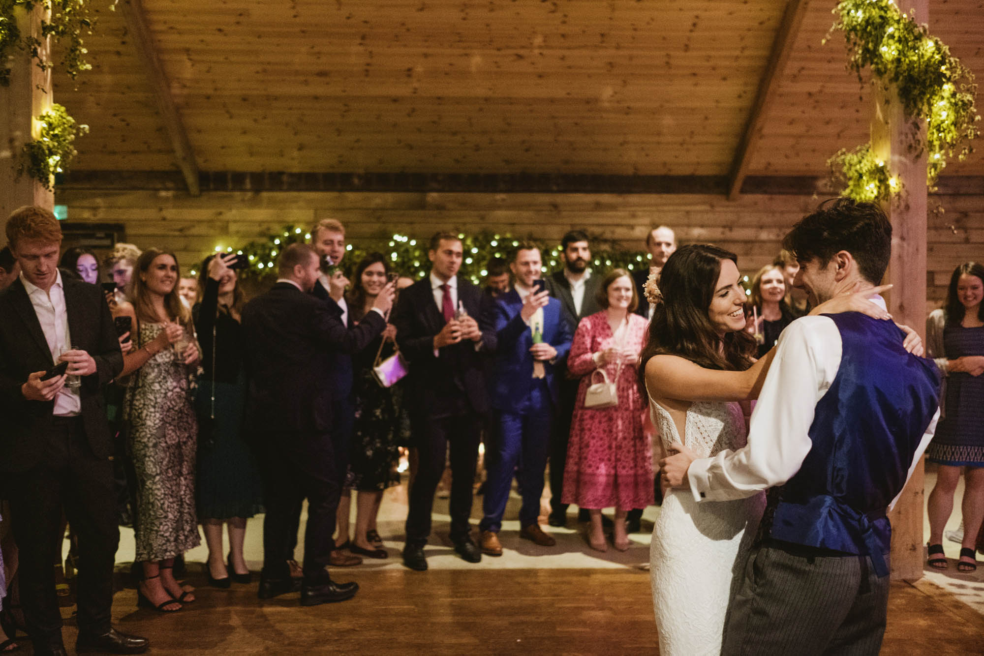 A natural wedding photo with guests enjoying Sophie and Chris's wedding day in Surrey. By York Place Studios who are London and UK award winning documentary photographers