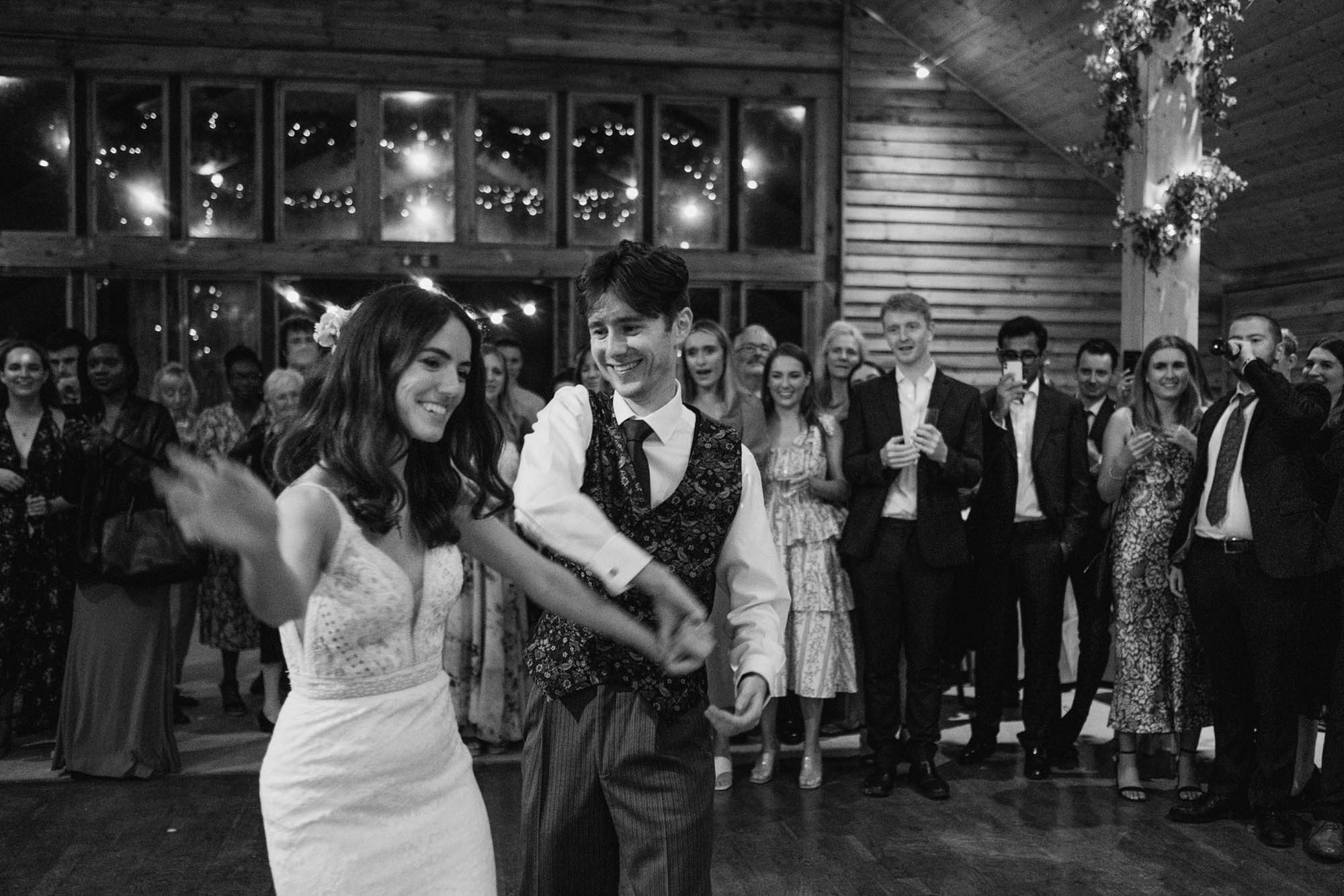 A natural wedding photo with guests enjoying Sophie and Chris's wedding day in Surrey. By York Place Studios who are London and UK award winning documentary photographers