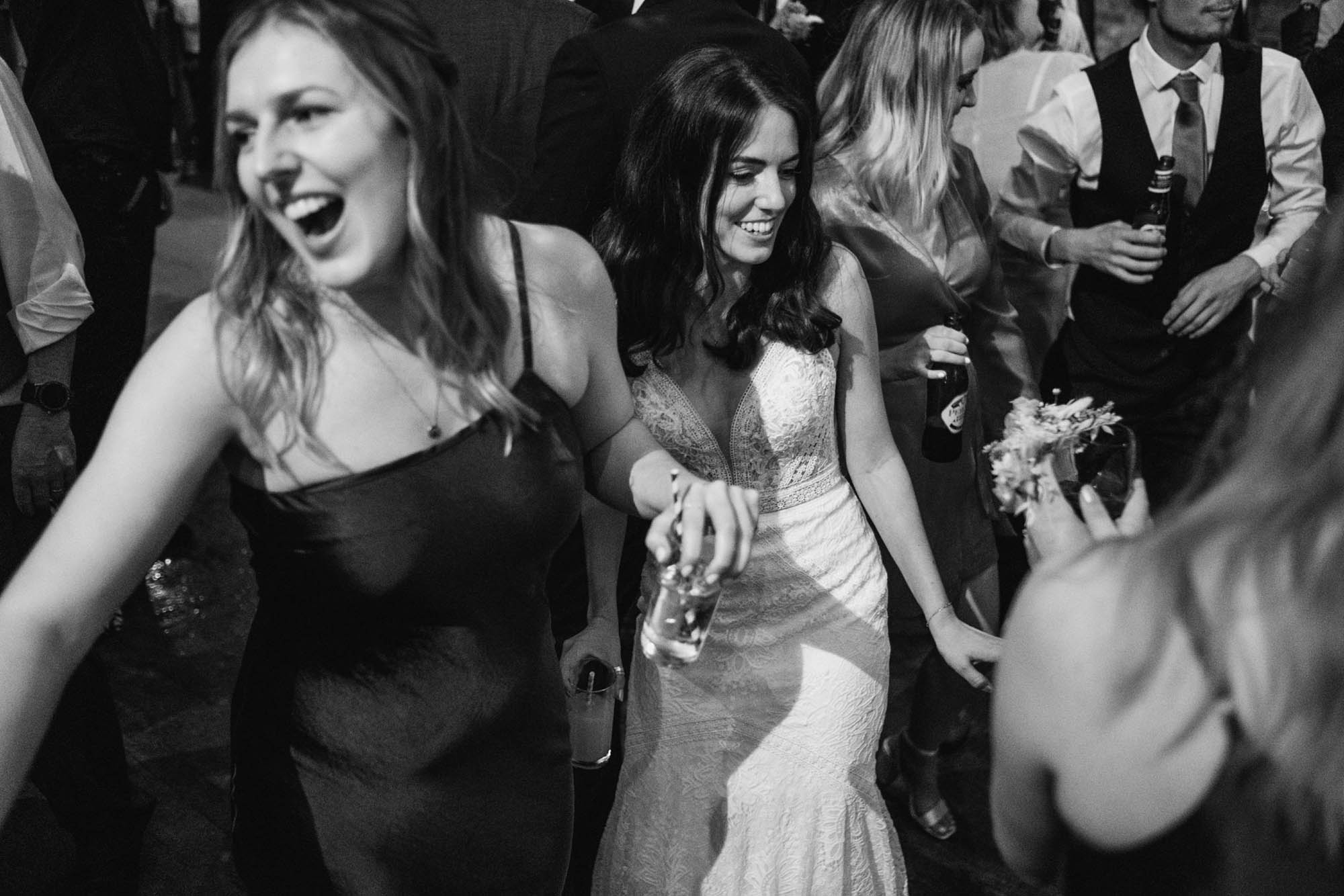 A natural wedding photo with guests enjoying Sophie and Chris's wedding day in Surrey. By York Place Studios who are London and UK award winning documentary photographers