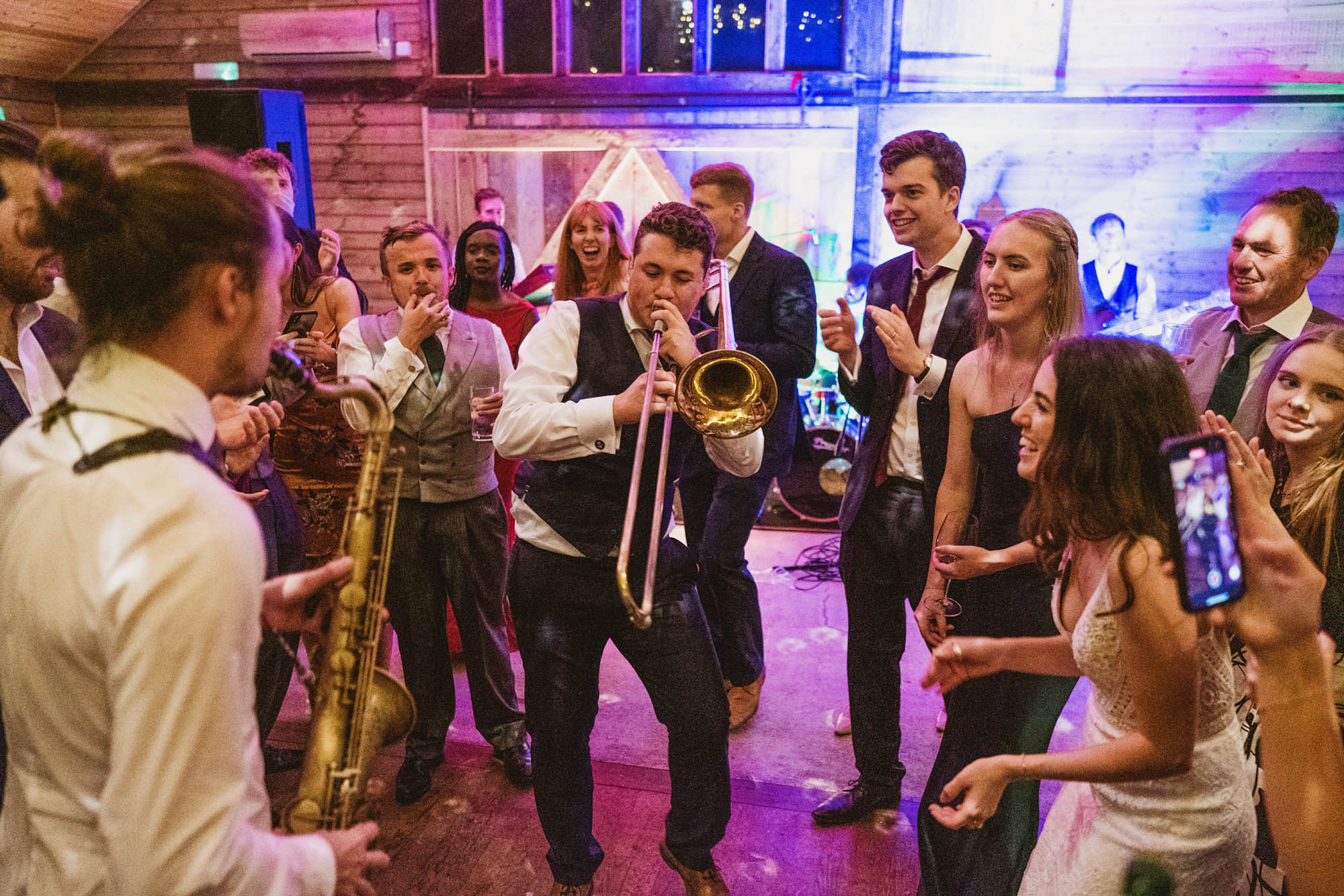 A natural wedding photo with guests enjoying Sophie and Chris's wedding day in Surrey. By York Place Studios who are London and UK award winning documentary photographers