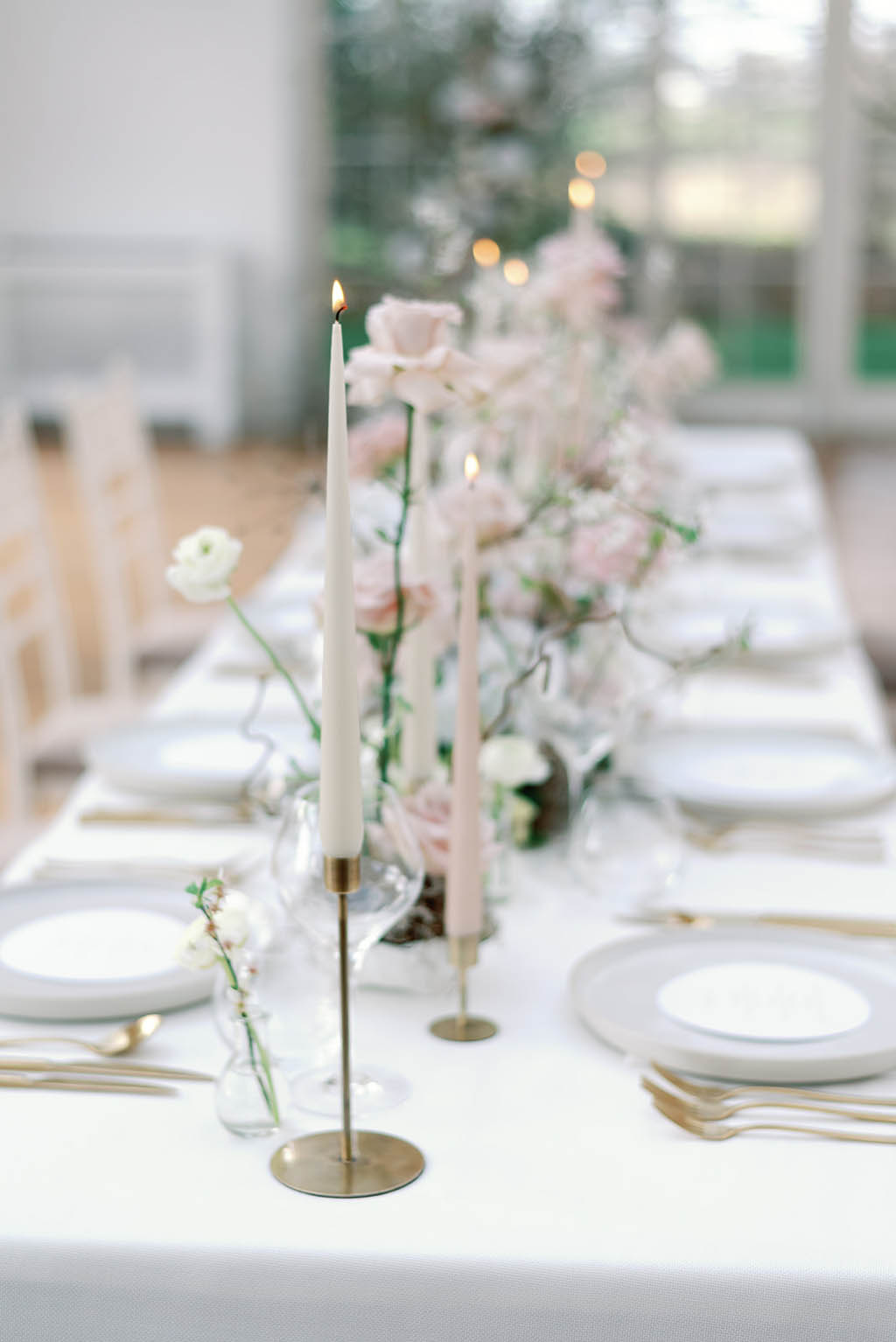 delicate wedding table colour palette with taper candles in palest blush and white