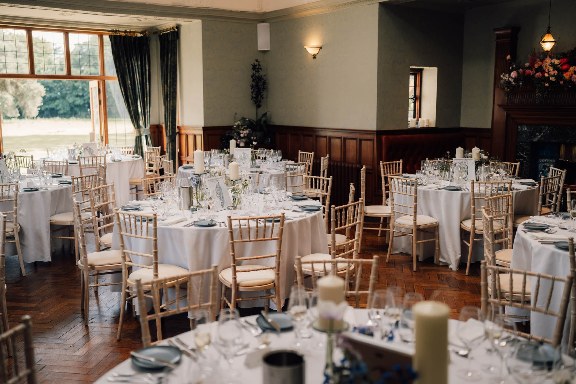 Inside Burtonfields Hall Yorkshire for Megan and Dom's wedding. Tables are set for the reception. Photo by Joss Denham